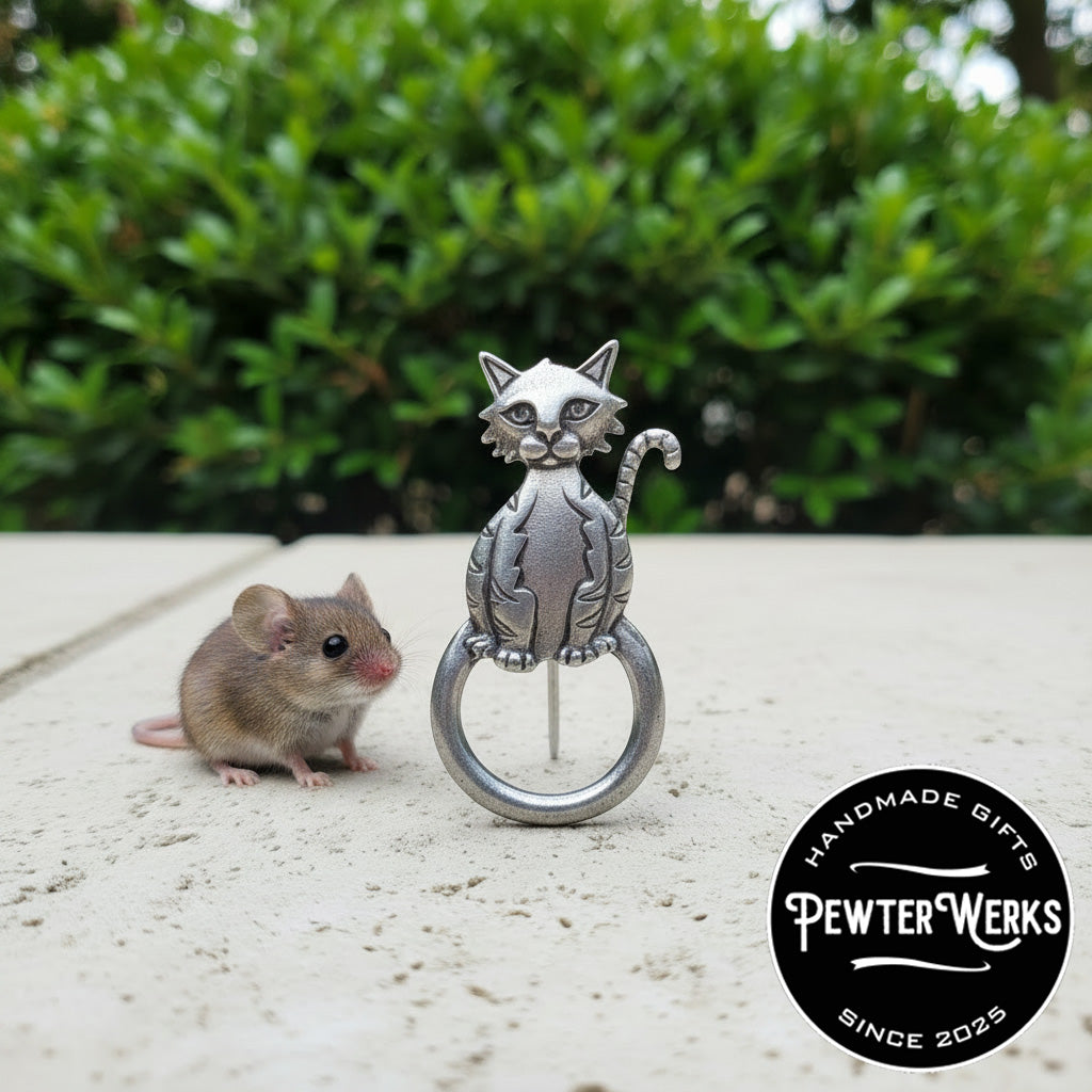 A Pewter 'Another Cat' Eyeglass Holder standing on the sidewalk next to a mouse. PewterWerks logo visible.