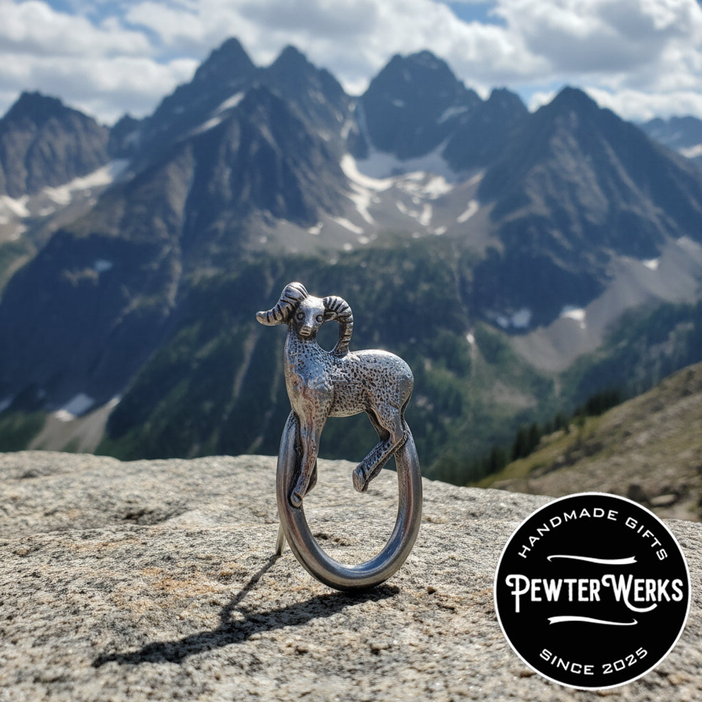 A Pewter 'Big Horn' Eyeglass Holder standing on a rock in the mountains. PewterWerks logo visible.