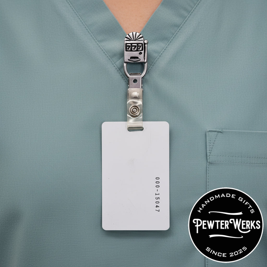 An ID Badge clipped to 'Slot Machine' Eyeglass Holder pinned on a healthcare worker. PewterWerks logo visible.